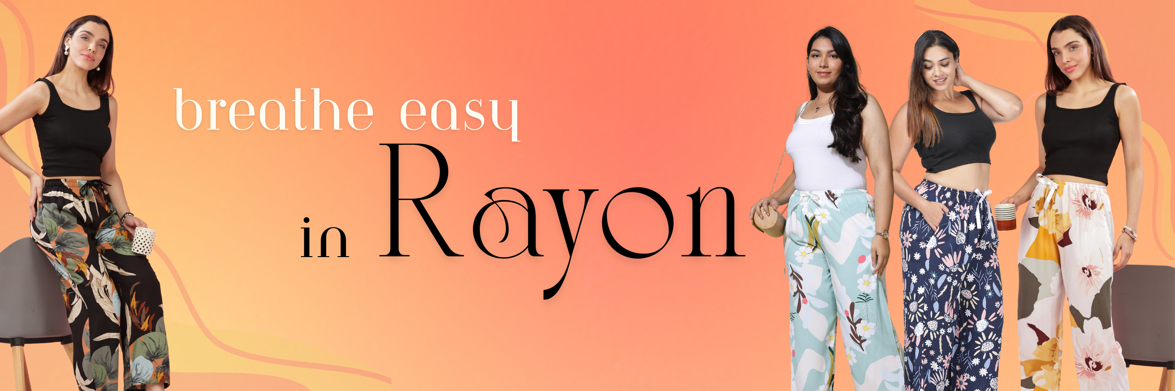 Four women wearing colorful, breathable rayon palazzo pants with floral and graphic prints, styled with black and white tops, against an orange background with the text 'Breathe Easy in Rayon'